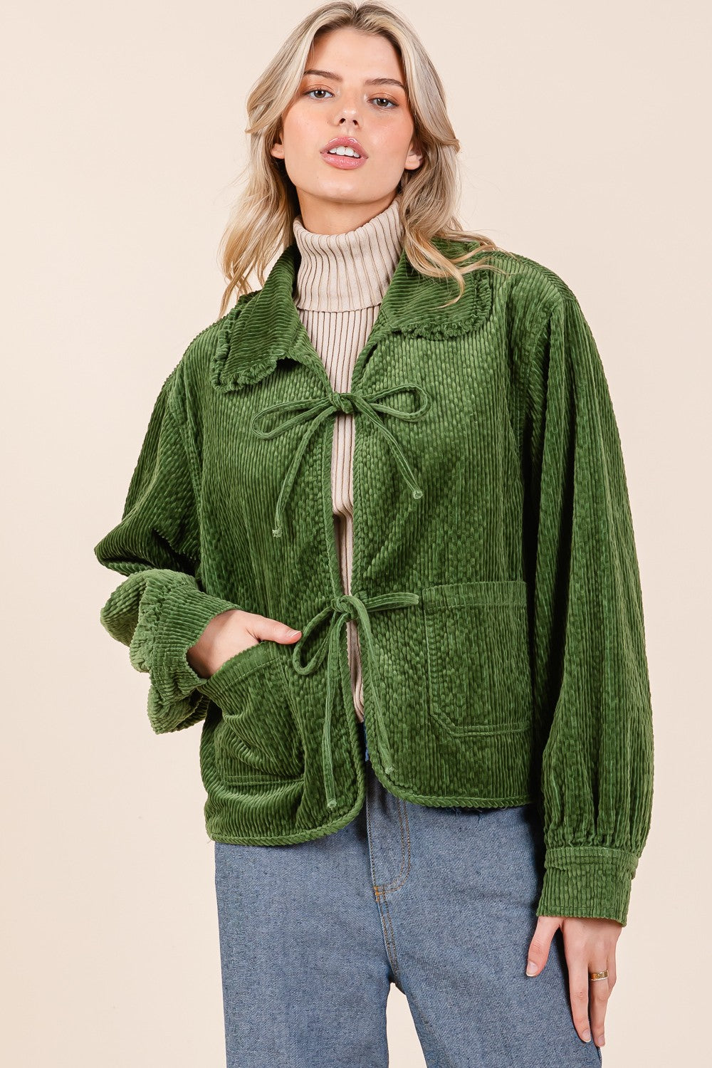 The Ruffle Charm Corduroy Jacket in green features a stylish design with ruffle accents. Available in sizes XS to XL.