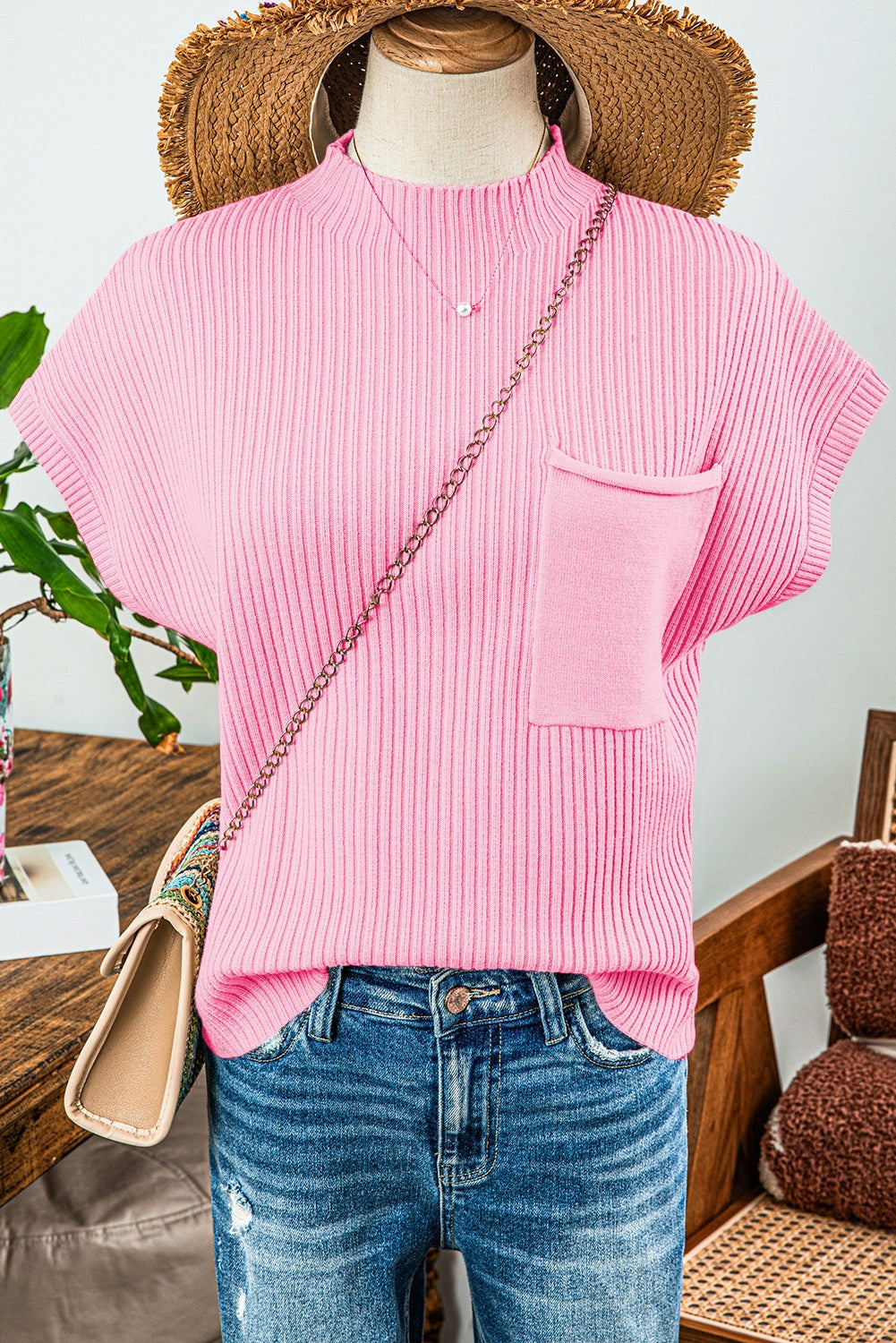 The Patch Pocket Ribbed Knit Sweater in pink features short sleeves and a patch pocket. Available sizes: XS, S, M, L, XL.