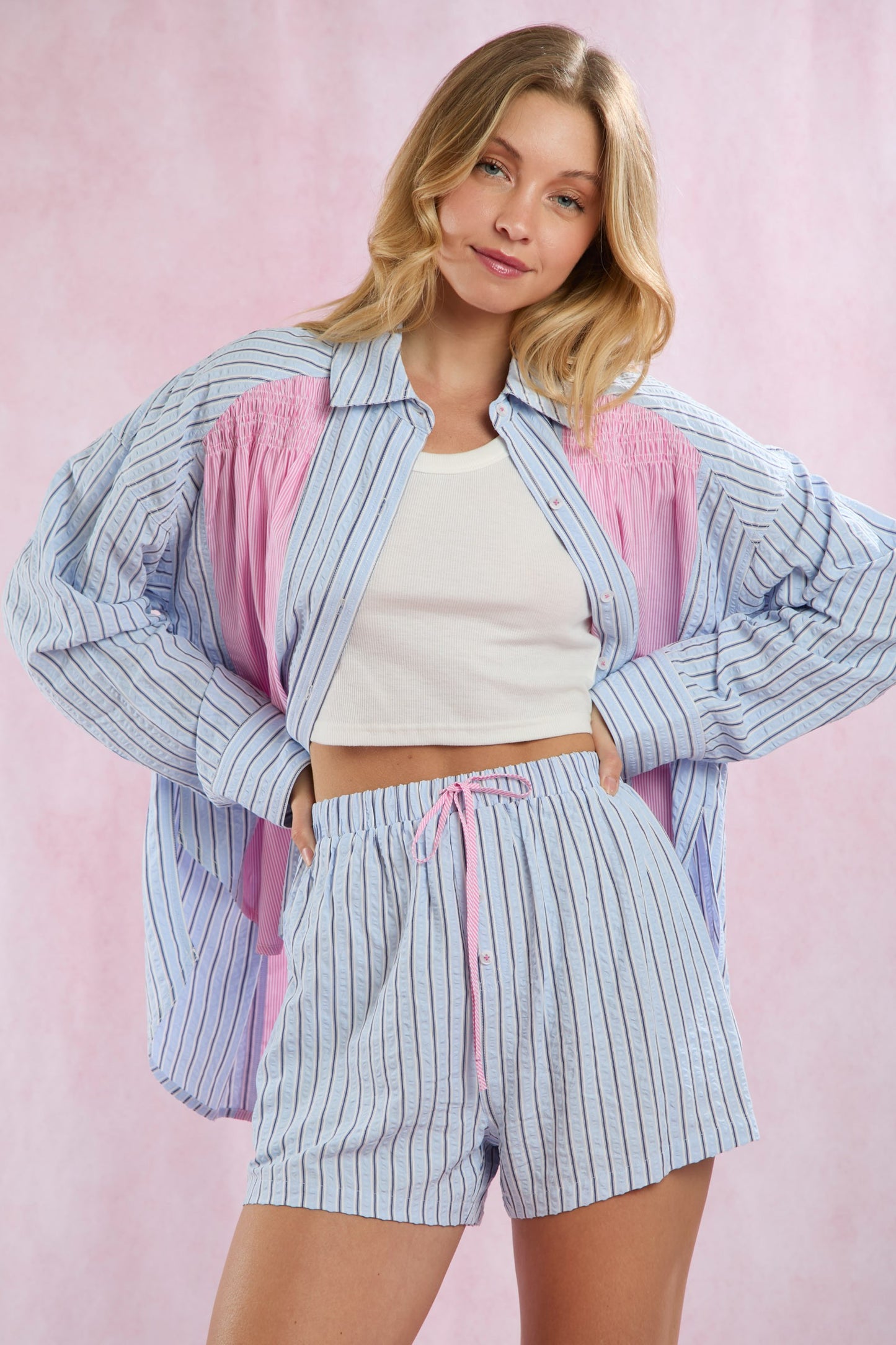 Blue and white striped lightweight summer shirt with pink accents, shirring detail, button up. Available in sizes XS-XL.