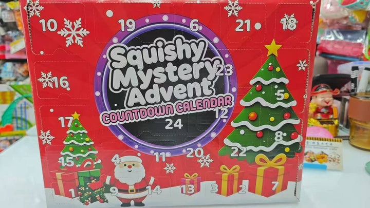 Squishy Mystery Calendar Countdown box with numbers 1 through 24, Christmas tree, Santa Claus, and snowflakes.