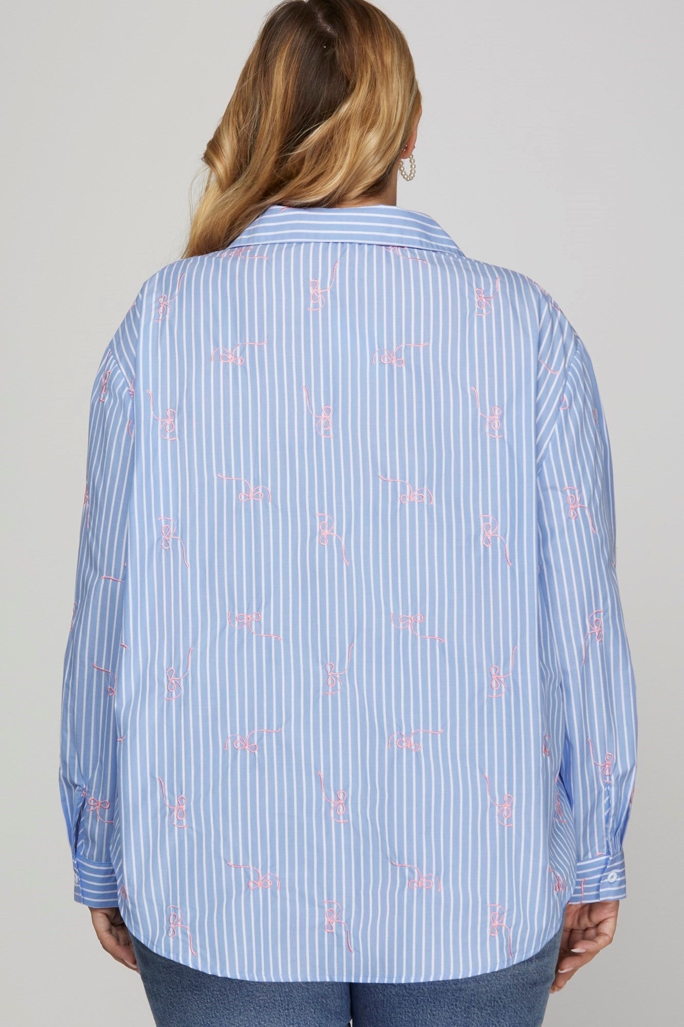 The Embroidered Bow Striped Button Down Top features blue and white stripes with pink embroidered designs. Available sizes: XS, S, M, L, XL.