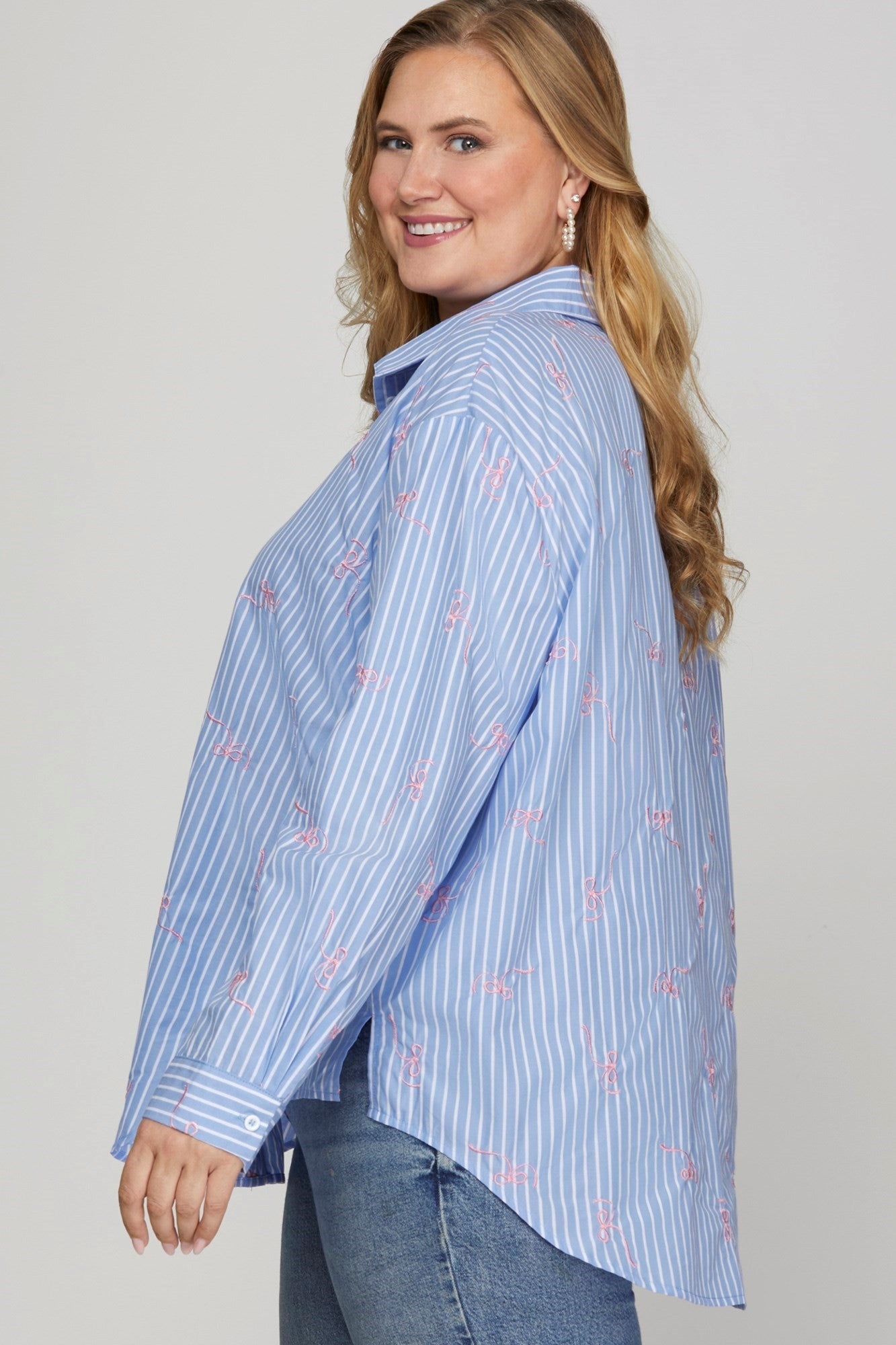 The Embroidered Bow Striped Button Down Top features a tailored fit with delicate embroidery and bow details. Available sizes: XS, S, M, L, XL.