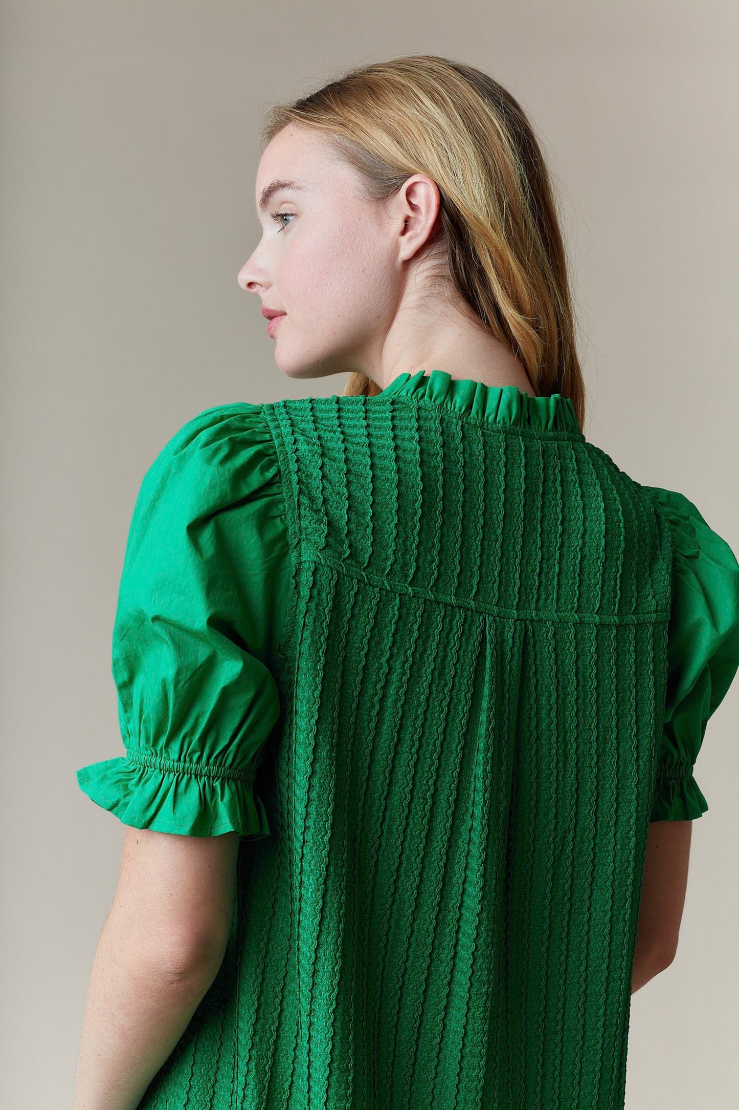 Greenly Dress with textured fabric, puffed sleeves, and ruffle collar. Available in sizes XS–XL.
