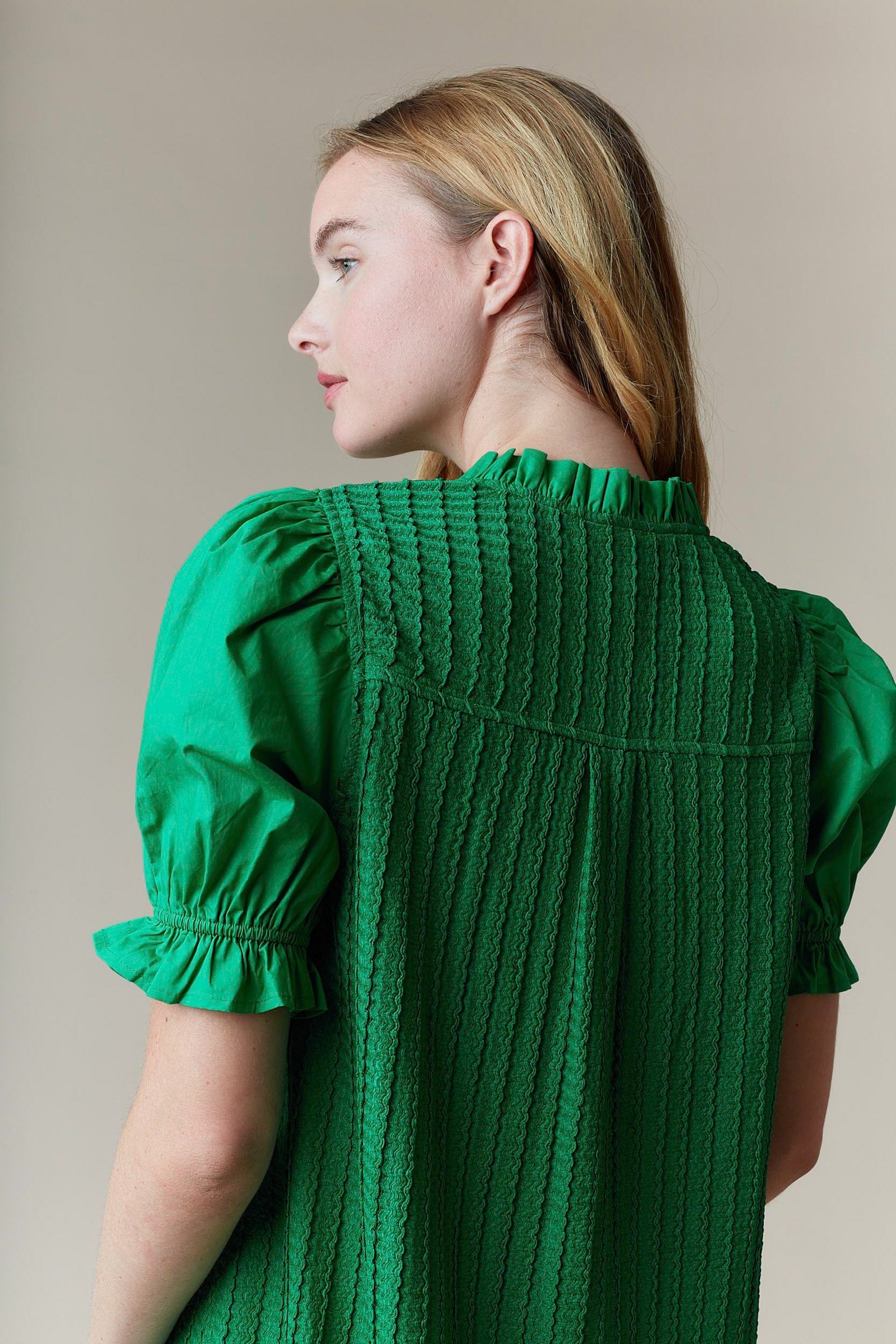 Greenly Dress with textured fabric, puffed sleeves, and ruffle collar. Available in sizes XS–XL.