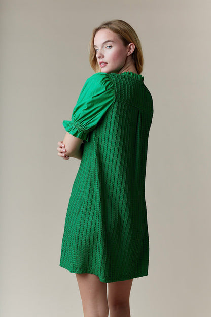 Greenly Dress with short sleeves, textured fabric, ruffle collar. Available in sizes XS–XL.