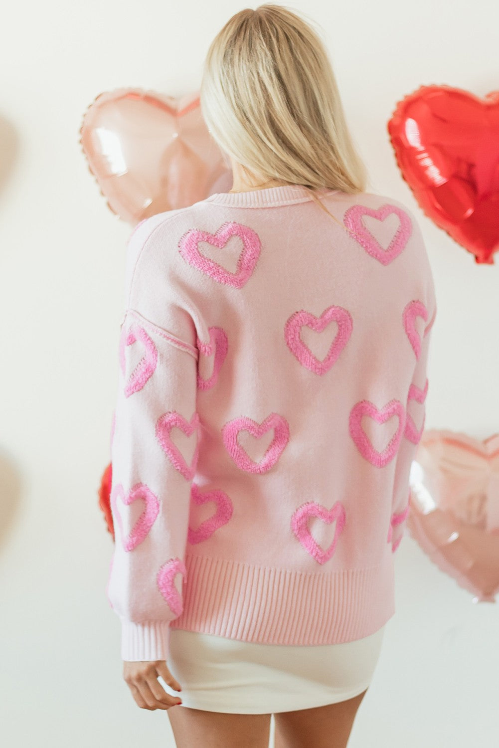 Heart Shape Bubble Sleeve Baggy Sweater in pink with a playful heart pattern. Available sizes: S, M, L, XL.
