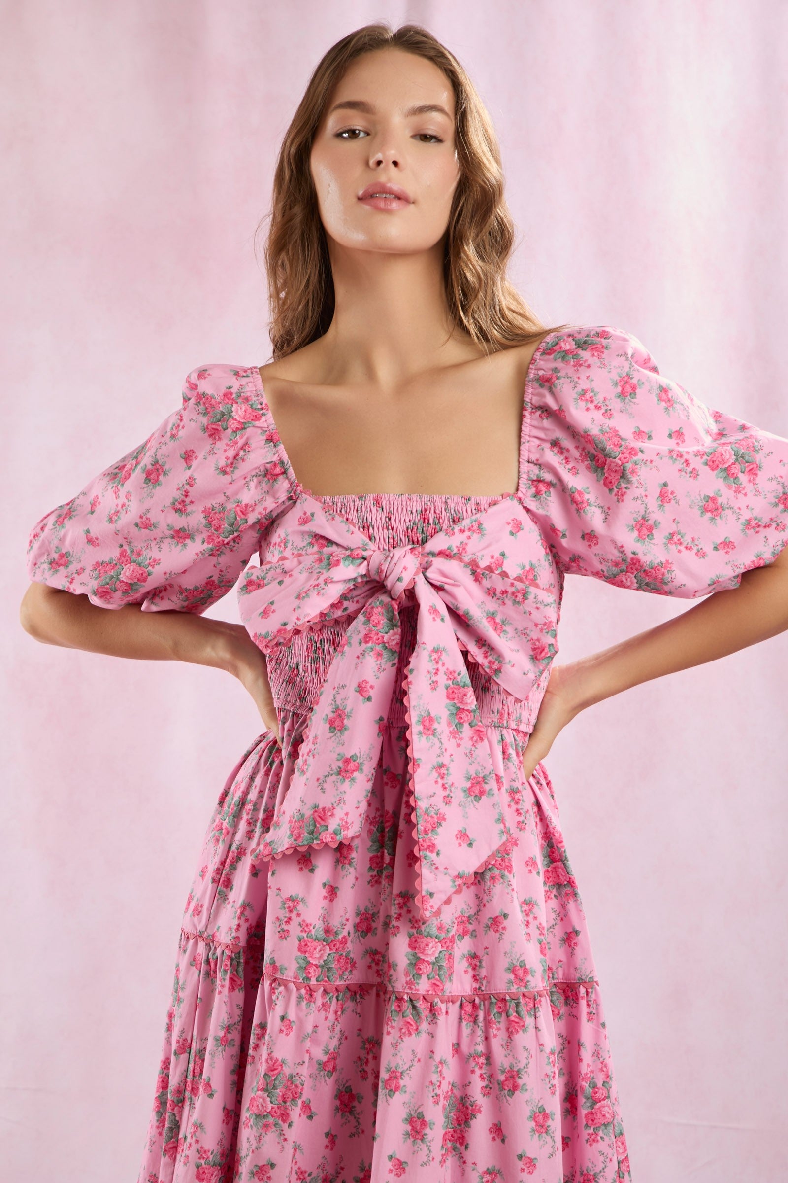 Bailey Floral Bow Front Maxi Dress featuring puffed sleeves and a large front bow. Available in sizes XS-XL.