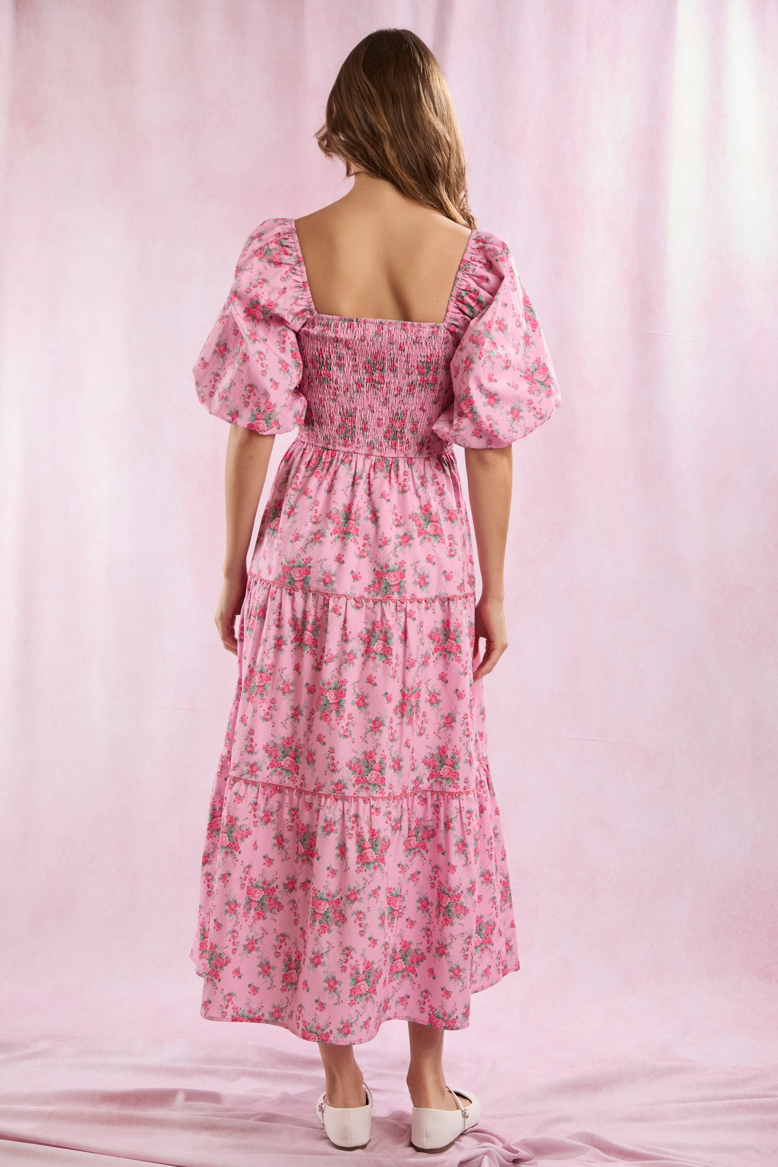 Bailey Floral Bow Front Maxi Dress: Pink floral maxi with puff sleeves, square neck, smocked back, bow front, and tiered skirt. Sizes available: XS–XL.
