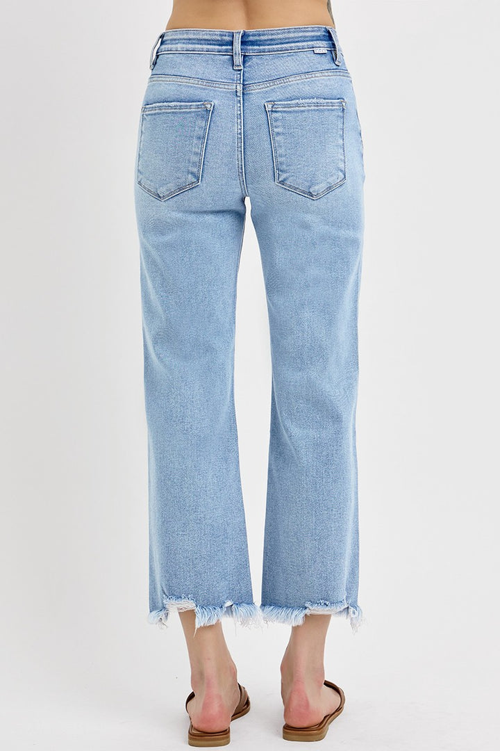 Risen Light Wash Mid Rise Crop Straight Jeans with distressed hem and back pockets. Available in sizes 24–32.