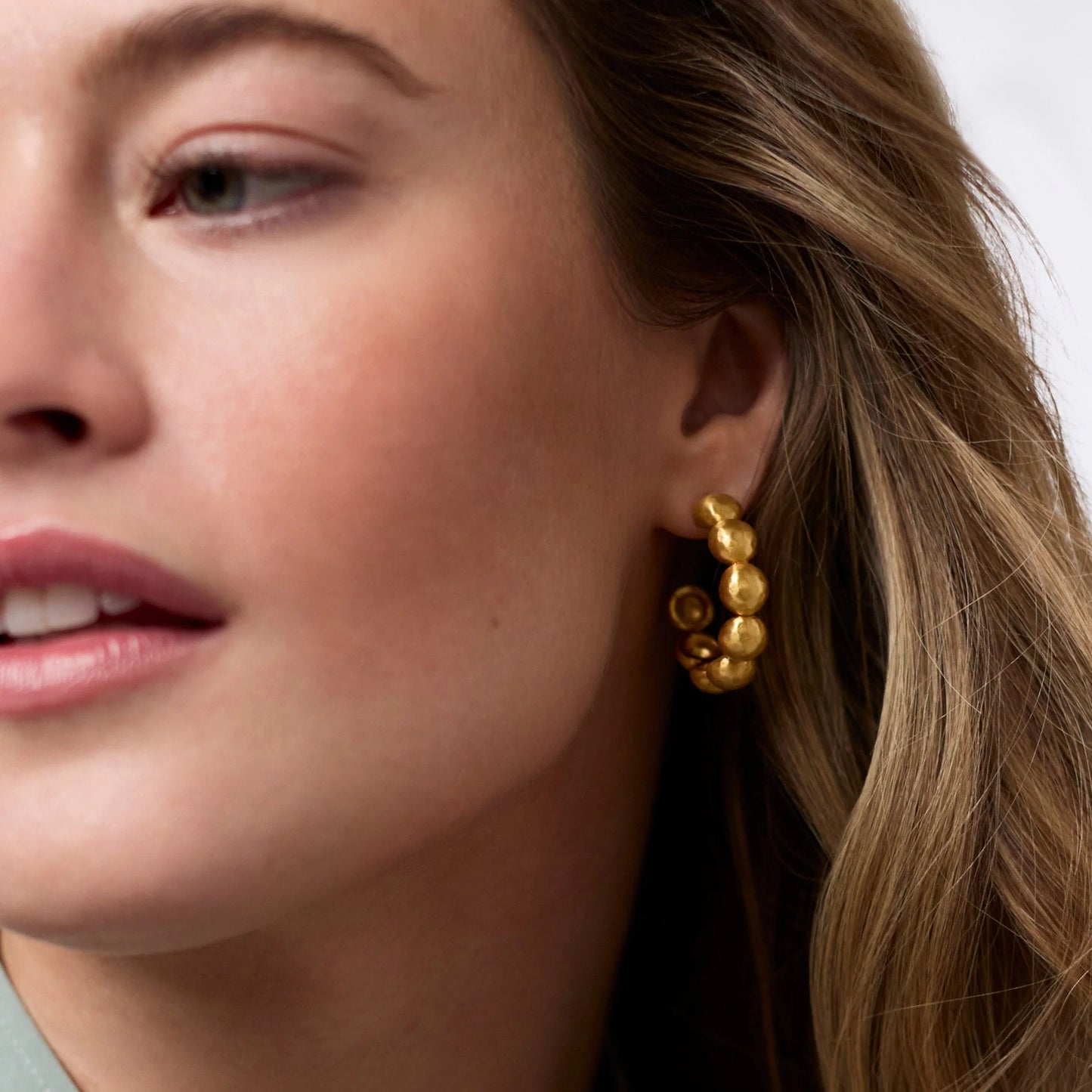 Solara Nova Hoop Earrings: chunky, textured gold hoops available in multiple sizes.