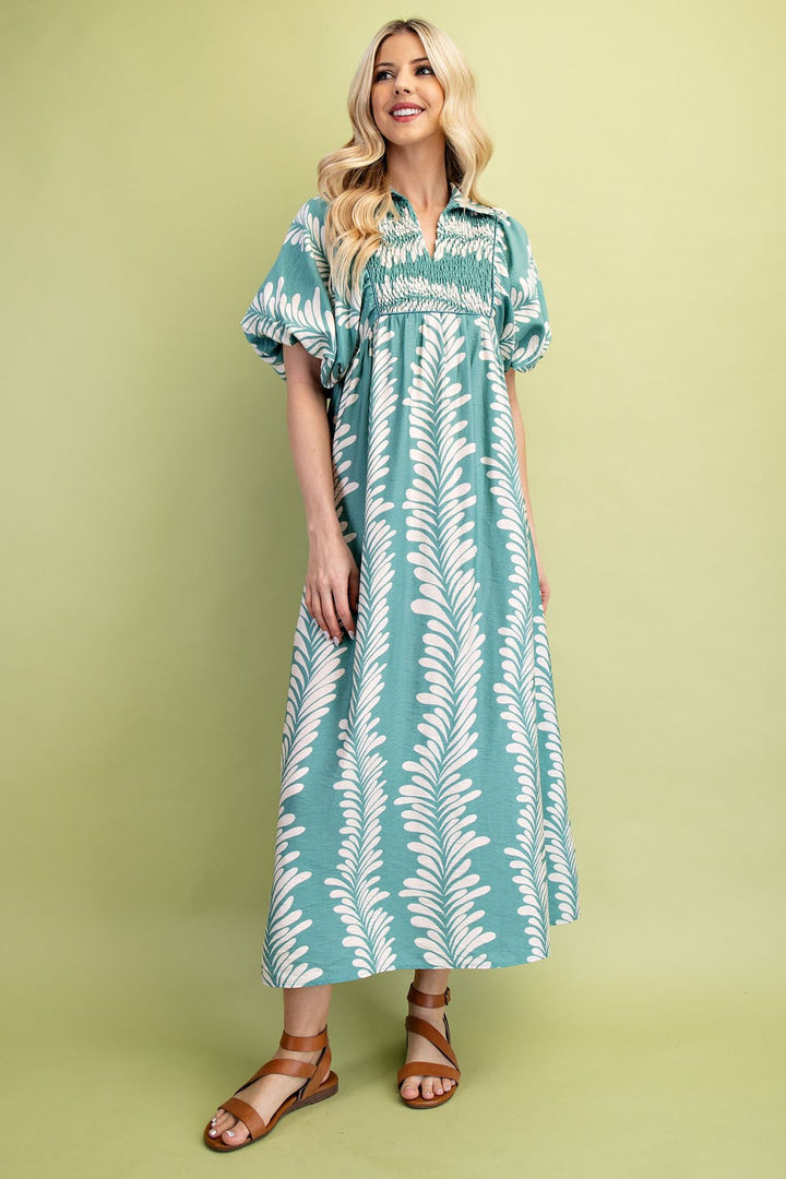 Printed Short Puff Sleeve Midi Dress with white leaf patterns and puff sleeves. Available in sizes XS-XL.
