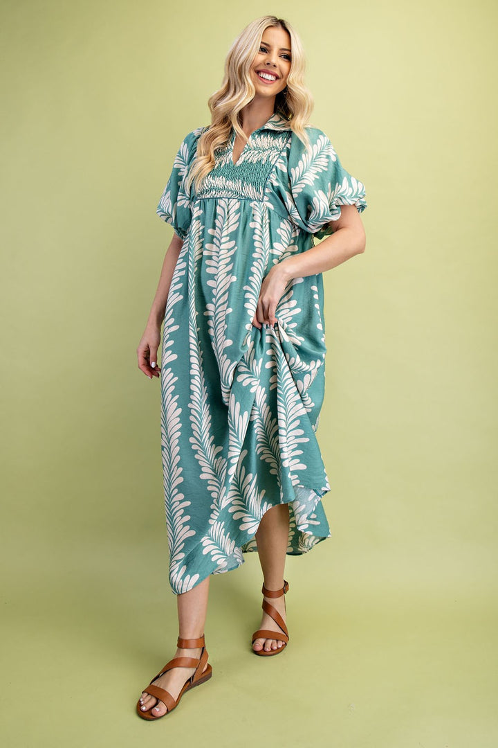 Printed Short Puff Sleeve Midi Dress with white leaf patterns. Available in sizes XS–XL.