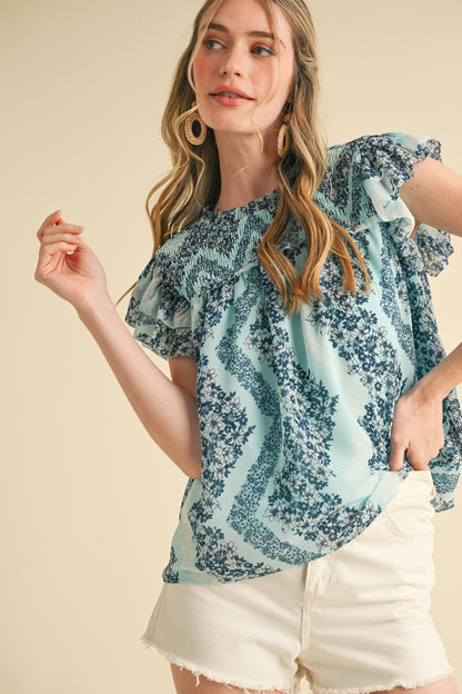 Teal Floral Smocked Yoke Ruffle Trim Top, available in sizes XS-XL.