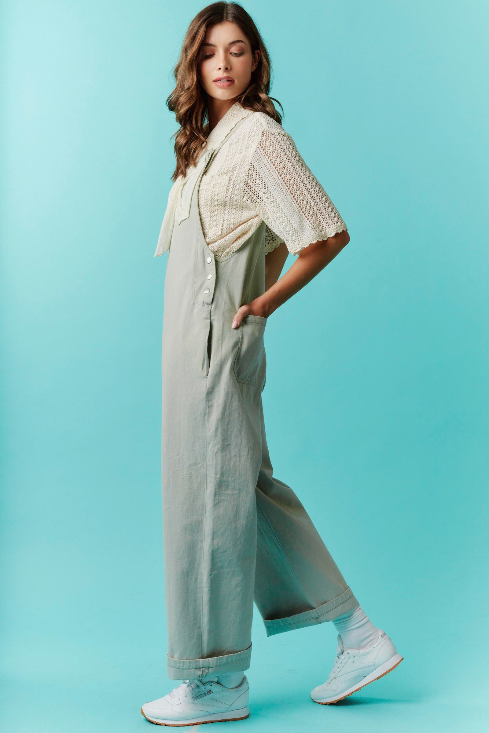 Twill Bow Overalls with adjustable straps. Available in sizes XS–XL.