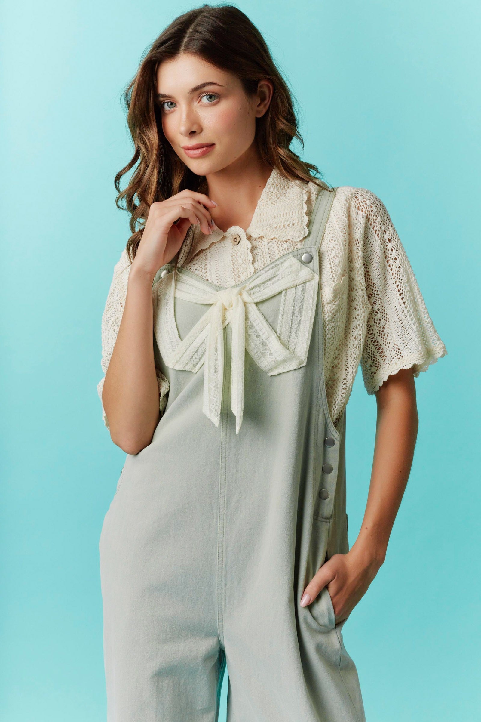 Twill Bow Overalls with adjustable straps. Available in sizes XS–XL.