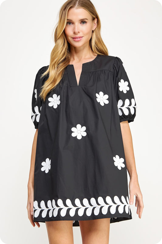 Ebony Blossom Embroidery Cotton Dress: loose-fit babydoll, white floral embroidery, puff sleeves, split neckline. Sizes XS–XL.