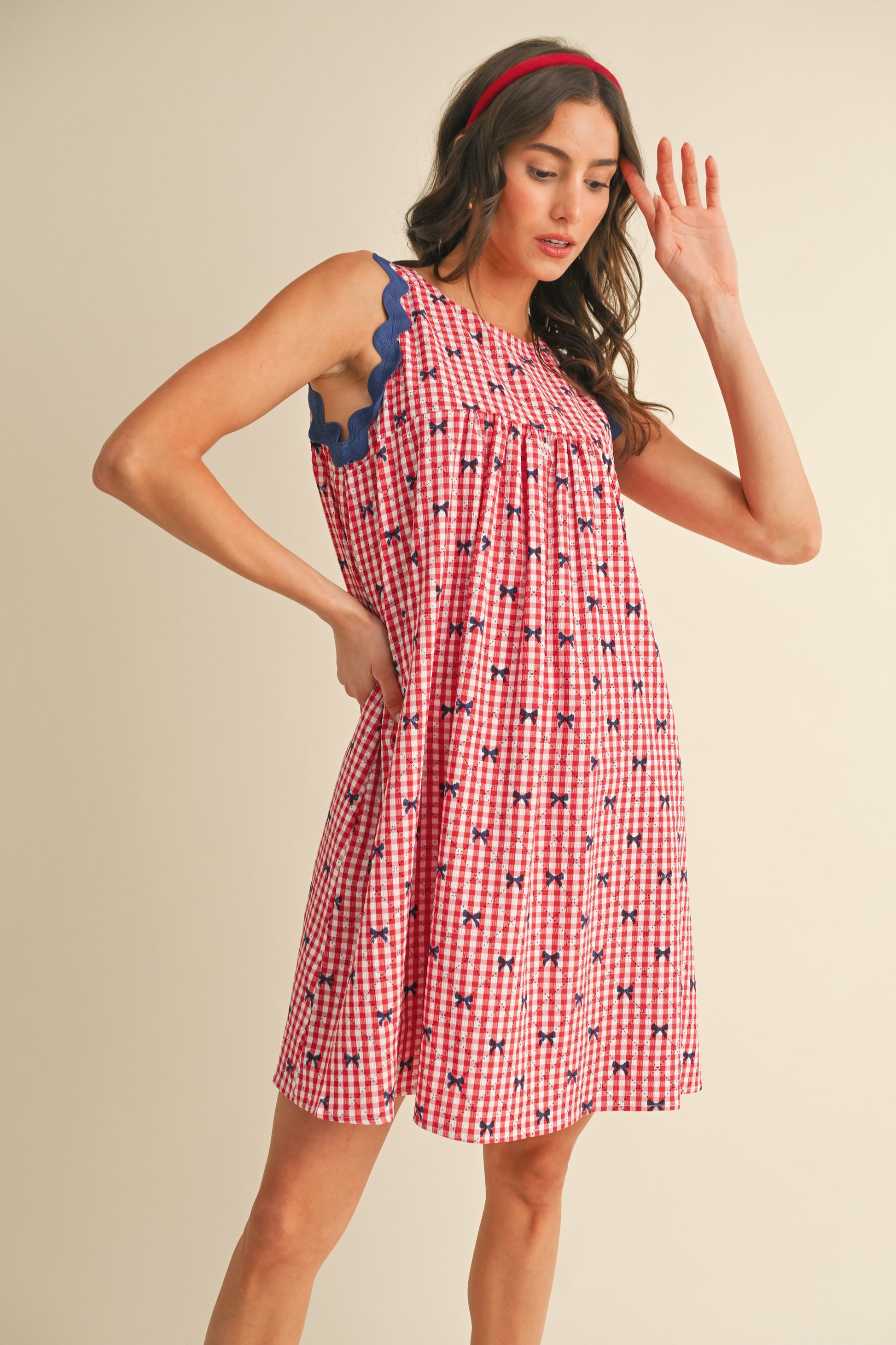 Miss Americana Bow Print Dress: Sleeveless red and white gingham with blue scalloped trim, bow print, pockets. Sizes: XS, S, M, L, XL.