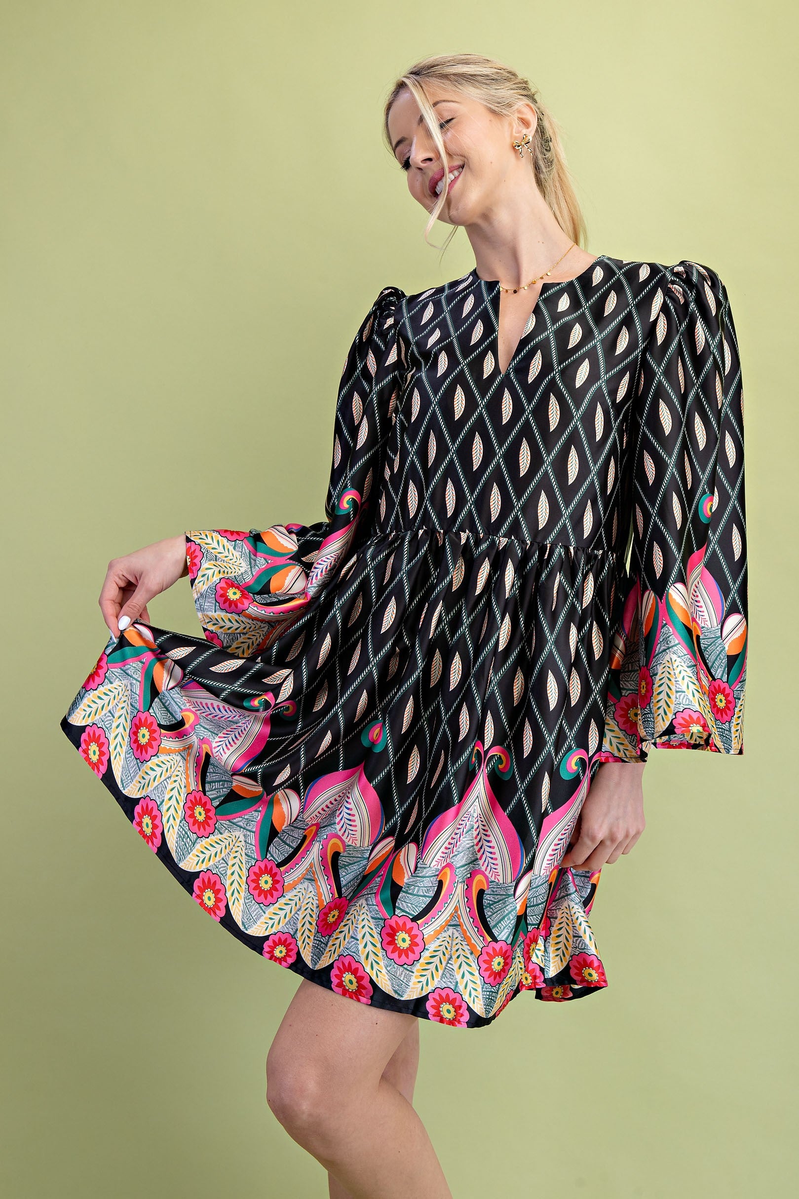 Nora Notch Neck Mini Dress with bold geometric and floral prints in black, pink, orange, and turquoise. Available in sizes XS–XL.