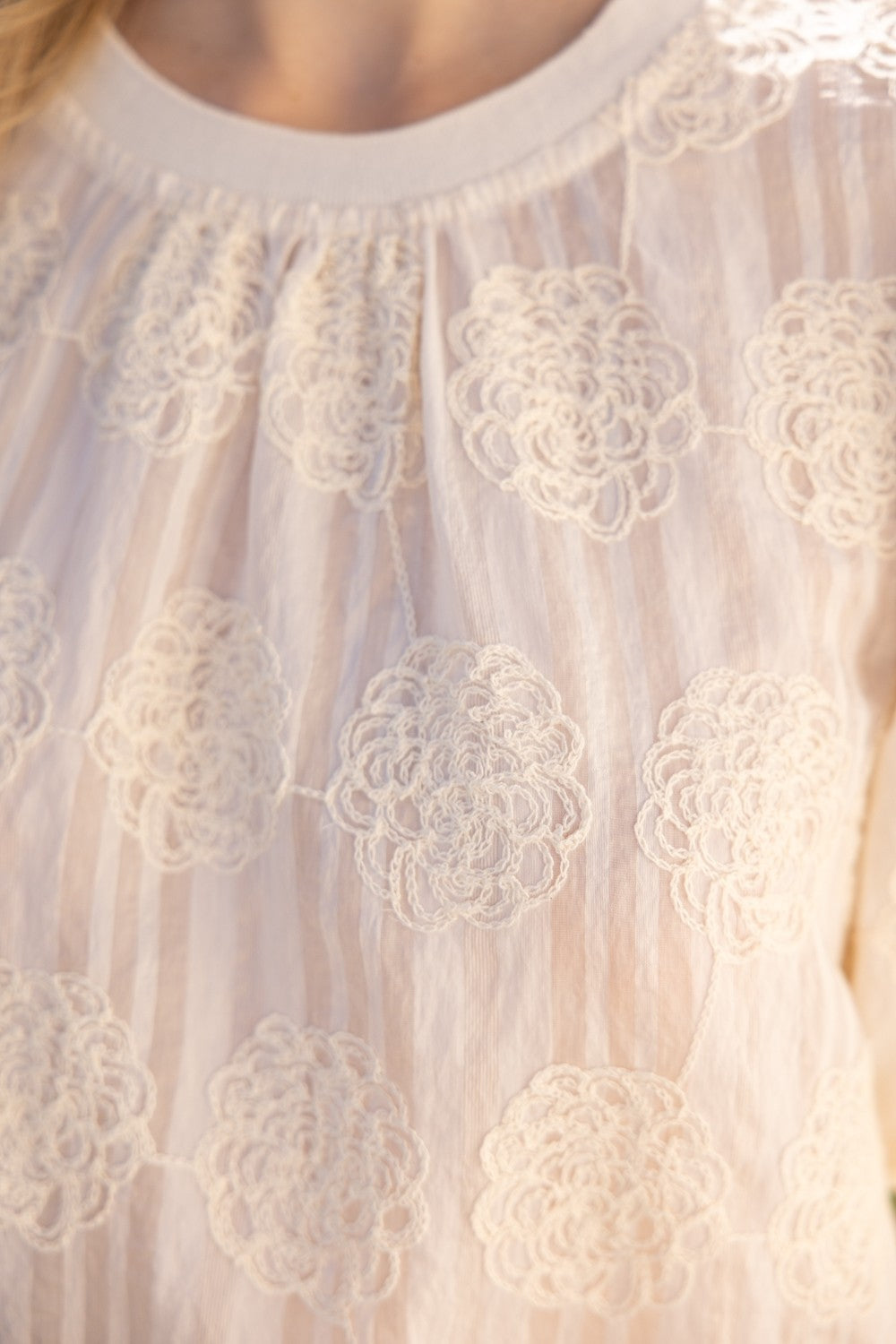 Tilly Elastic Knit Hem Embroidered Top in sheer light fabric, circular lace, vertical stripes. Available in sizes XS-XL.