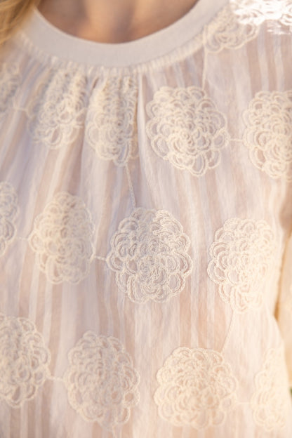 Tilly Elastic Knit Hem Embroidered Top in sheer light fabric, circular lace, vertical stripes. Available in sizes XS-XL.