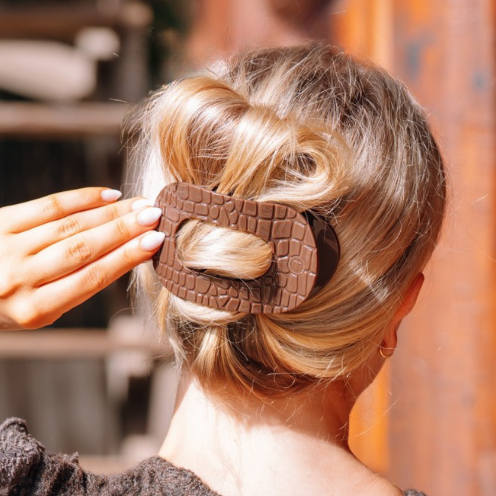 Brown Crocodile Large Flat Round Hair Clip securing hair; available in multiple sizes.