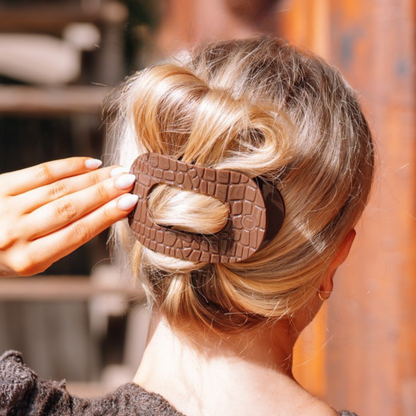 Brown Crocodile Large Flat Round Hair Clip securing hair; available in multiple sizes.