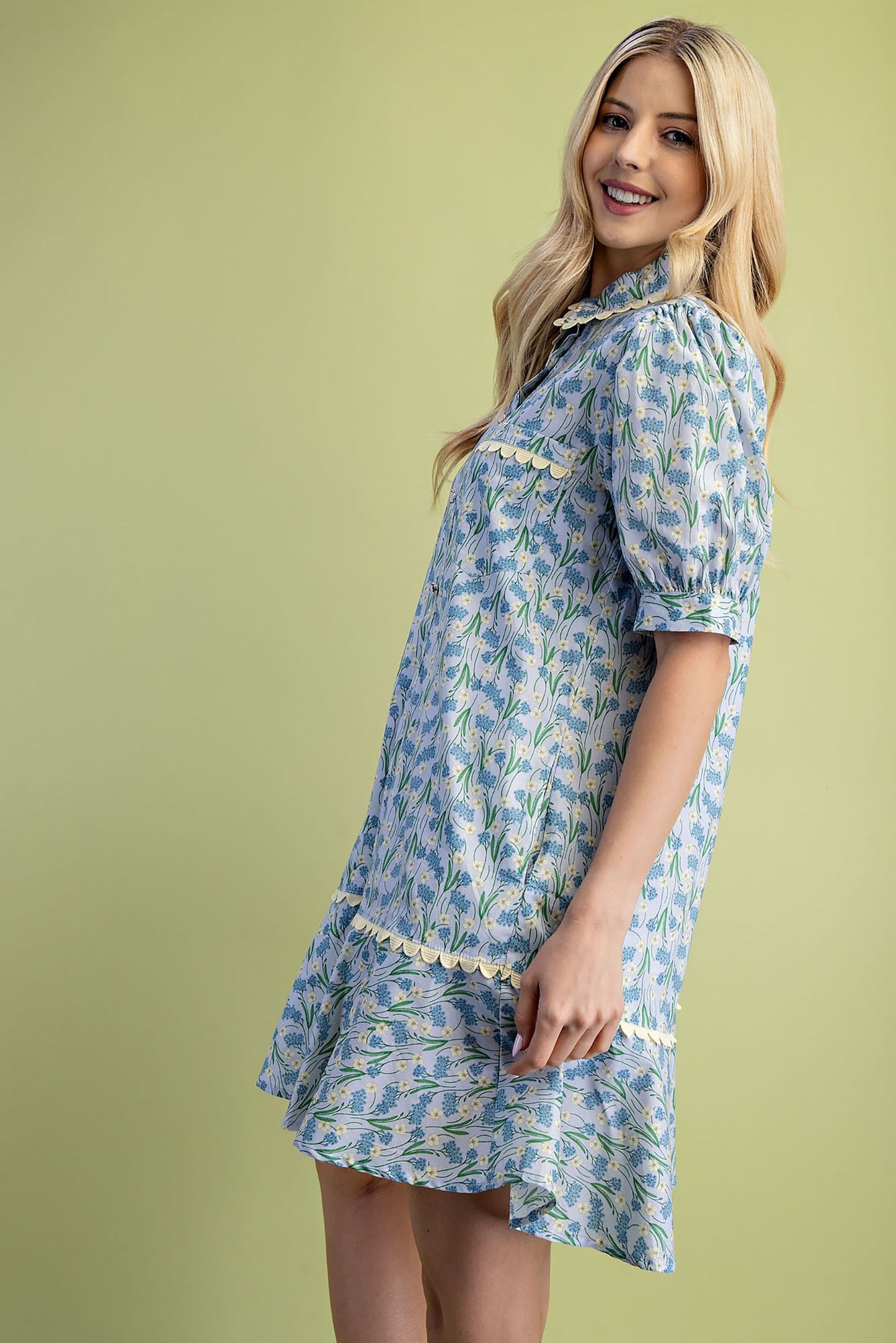 Mia Floral Print Mini Dress with blue and green flowers, short puff sleeves, and a ruffled hem. Available in sizes XS–L.