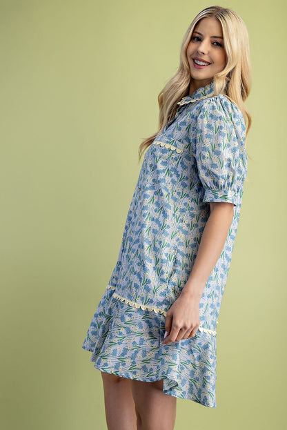 Mia Floral Print Mini Dress with blue and green flowers, short puff sleeves, and a ruffled hem. Available in sizes XS–L.