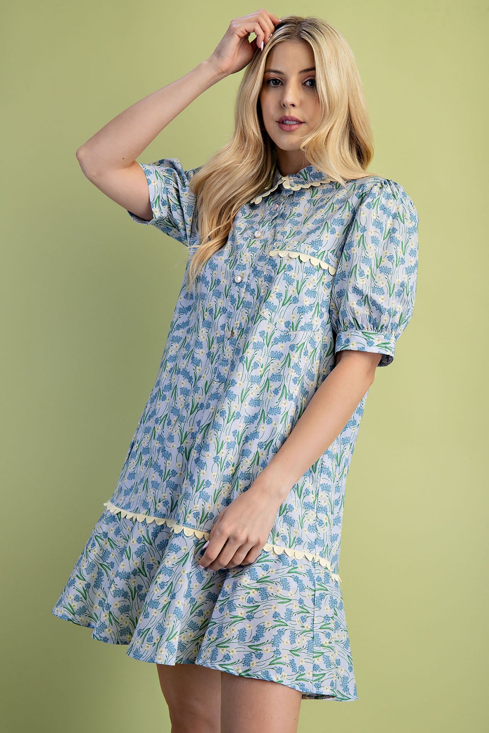 Mia Floral Print Mini Dress: 100% cotton, light blue and green floral pattern, puff sleeves, tiered skirt, scalloped trim. Available in sizes XS–XL.