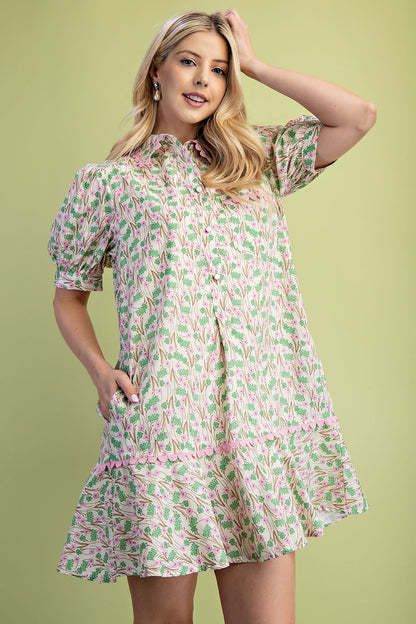 Mia Floral Print Mini Dress in lightweight 100% cotton with puff sleeves, ruffled hem, and pink and green floral pattern. Available in sizes XS–XL.