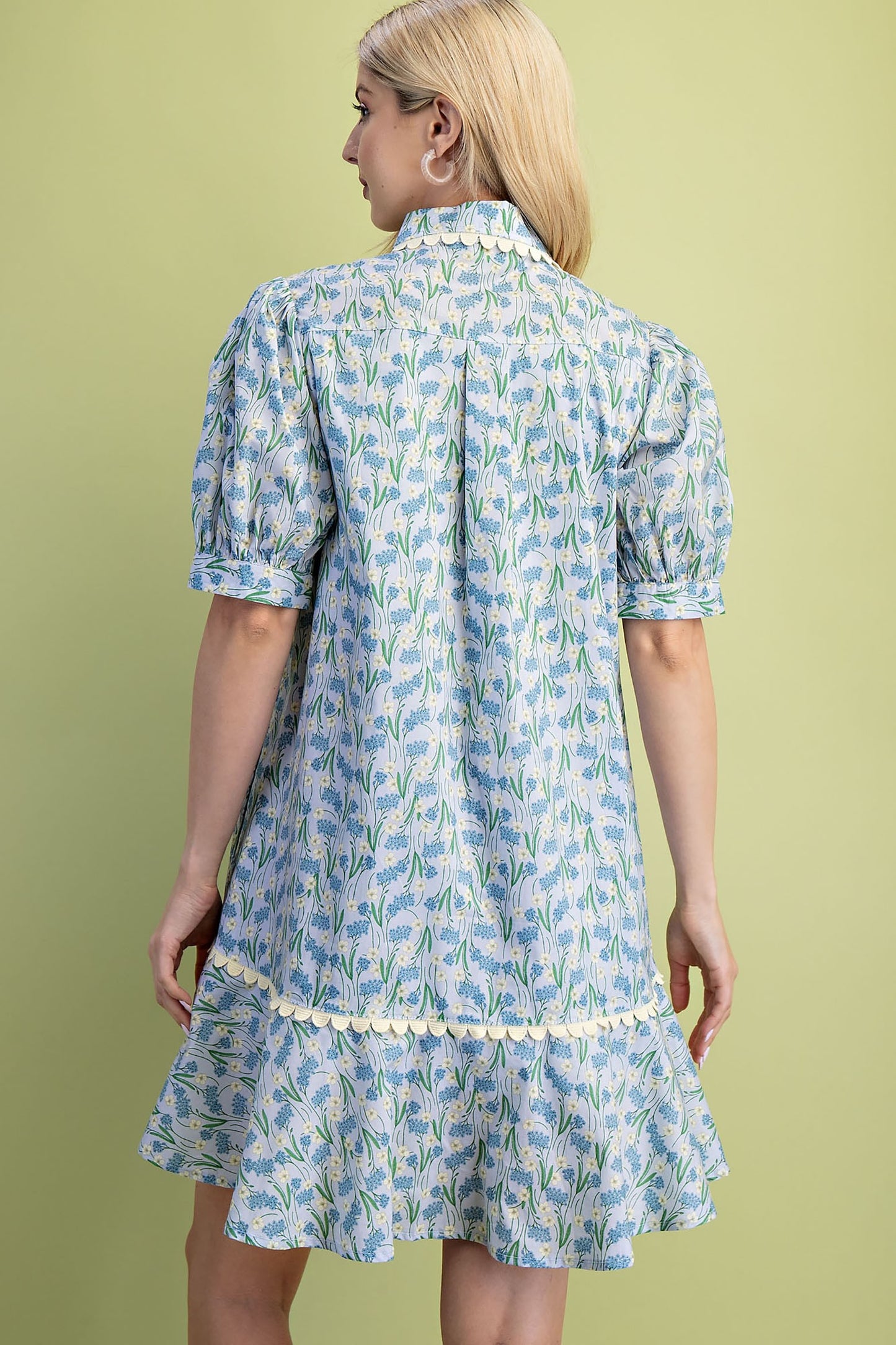 Mia Floral Print Mini Dress in light blue. Features short puff sleeves, ruffled hem, and lightweight 100% cotton fabric. Available in sizes XS-L.