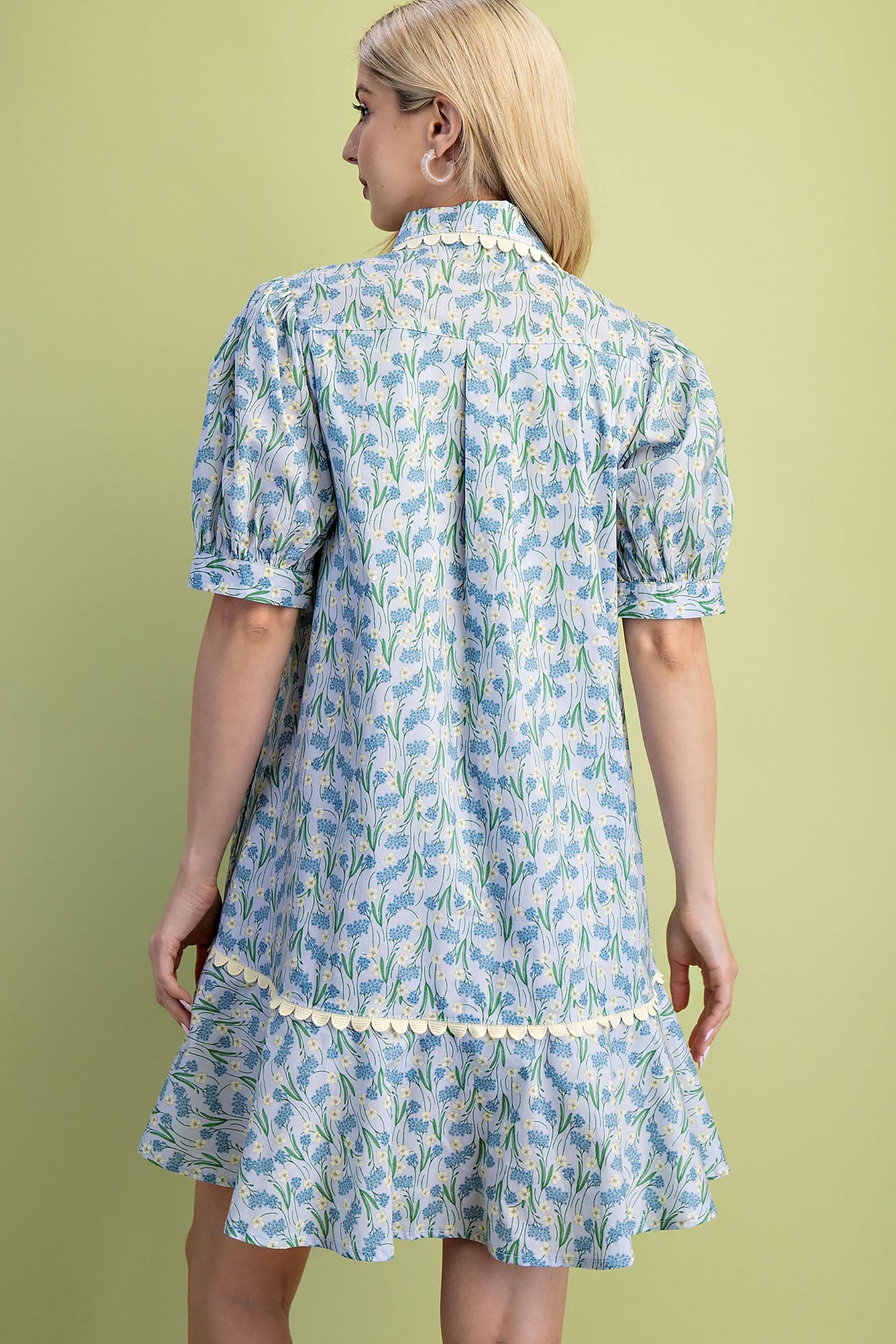 Mia Floral Print Mini Dress in light blue. Features short puff sleeves, ruffled hem, and lightweight 100% cotton fabric. Available in sizes XS-L.