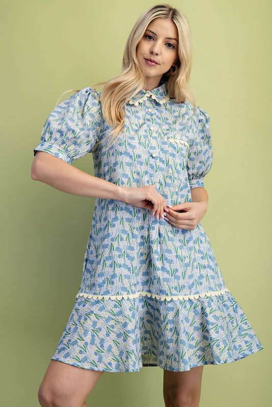 Mia Floral Print Mini Dress: Light blue floral pattern, puffed short sleeves, ruffled hem. Available in sizes XS–XL.