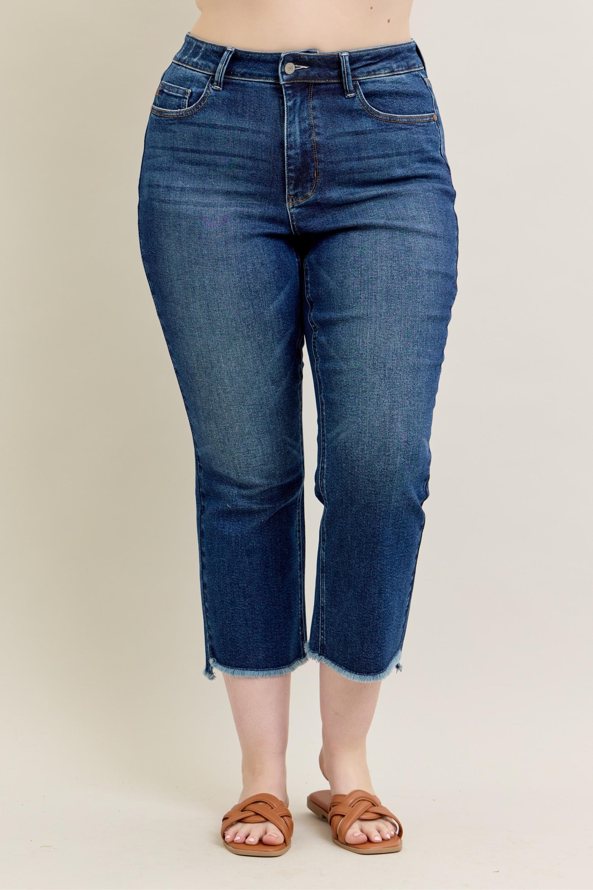 Judy Blue HW Dark Wash Kick Flare Jeans with high waist, cropped flare, raw hems. Available in sizes 0-20W.