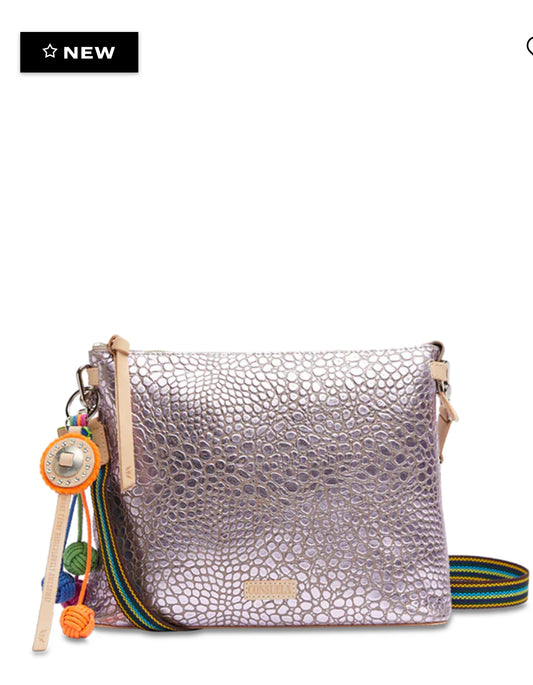 
DETAILS & SIZING

Lilac foiled leather exterior with pebbled embossing
Includes a leather concho charm with knotted nylon tassels
Austrian crystal details
Zipper closure
Interior slide pocket and credit card slots
Includes detachable and adjustable woven crossbody strap
Trimmed in natural, untreated 