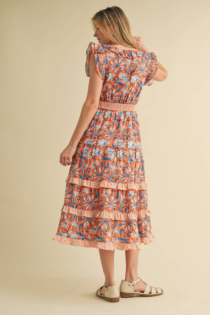 Mixed Floral Print Ruffle Trim Midi Dress with smocked waistband. Available in sizes XS-XL.