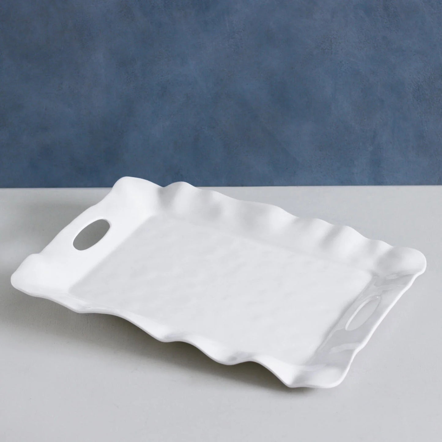 The VIDA Havana Rectangular Tray (White) has wavy edges, oval cut-out handles; available in small, medium, and large sizes.
