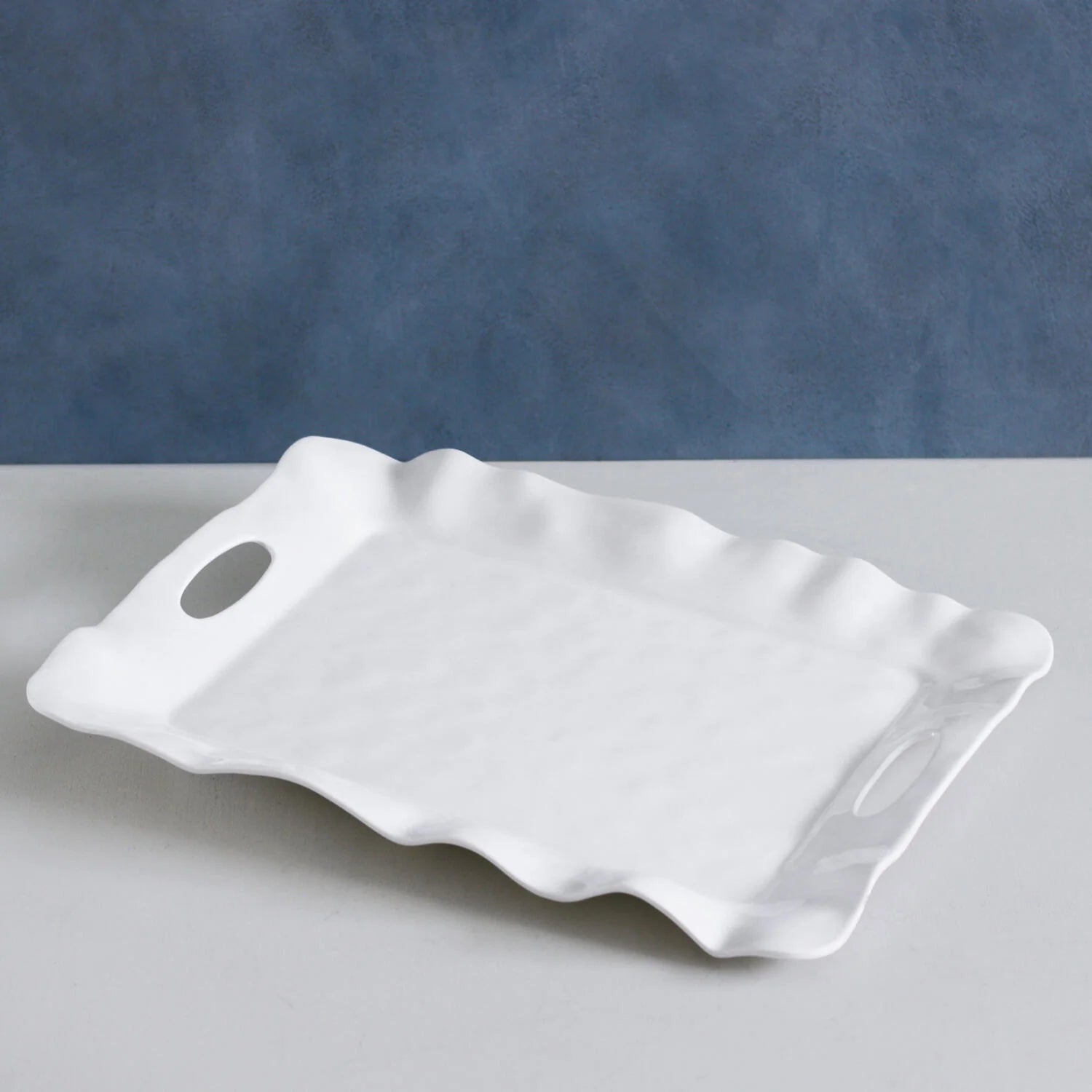The VIDA Havana Rectangular Tray (White) has wavy edges, oval cut-out handles; available in small, medium, and large sizes.