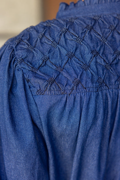 Diamond Textured Yoke Puff Sleeve Top in blue denim with diamond smocking detail. Available sizes: XS-XL.