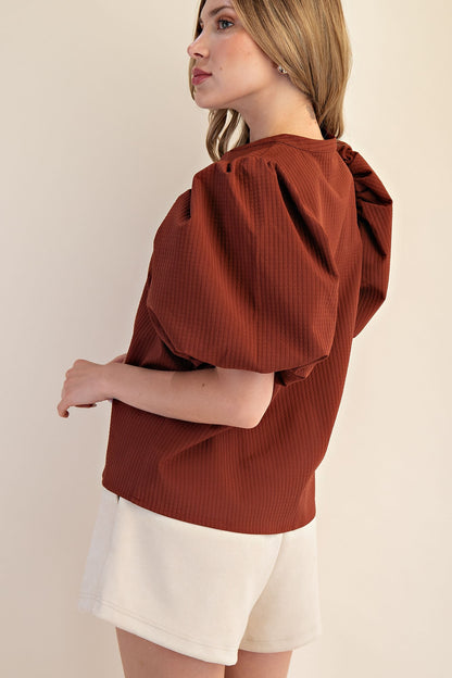 Rachel V-Neck Puff Sleeve Top in rust, featuring puff sleeves and v-neckline. Available in sizes XS-XL.