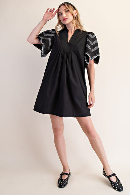 Heidi Balloon Sleeve Dress with puffed sleeves and white zigzag embroidery. Available in sizes XS-XL.