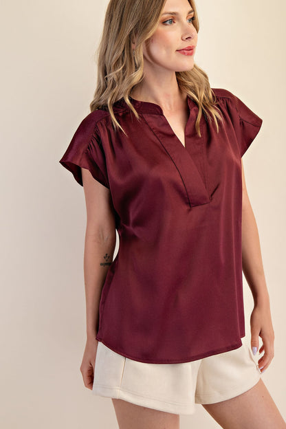 Jami Drop Cap Sleeve Satin Blouse in burgundy, available in sizes XS–XL.