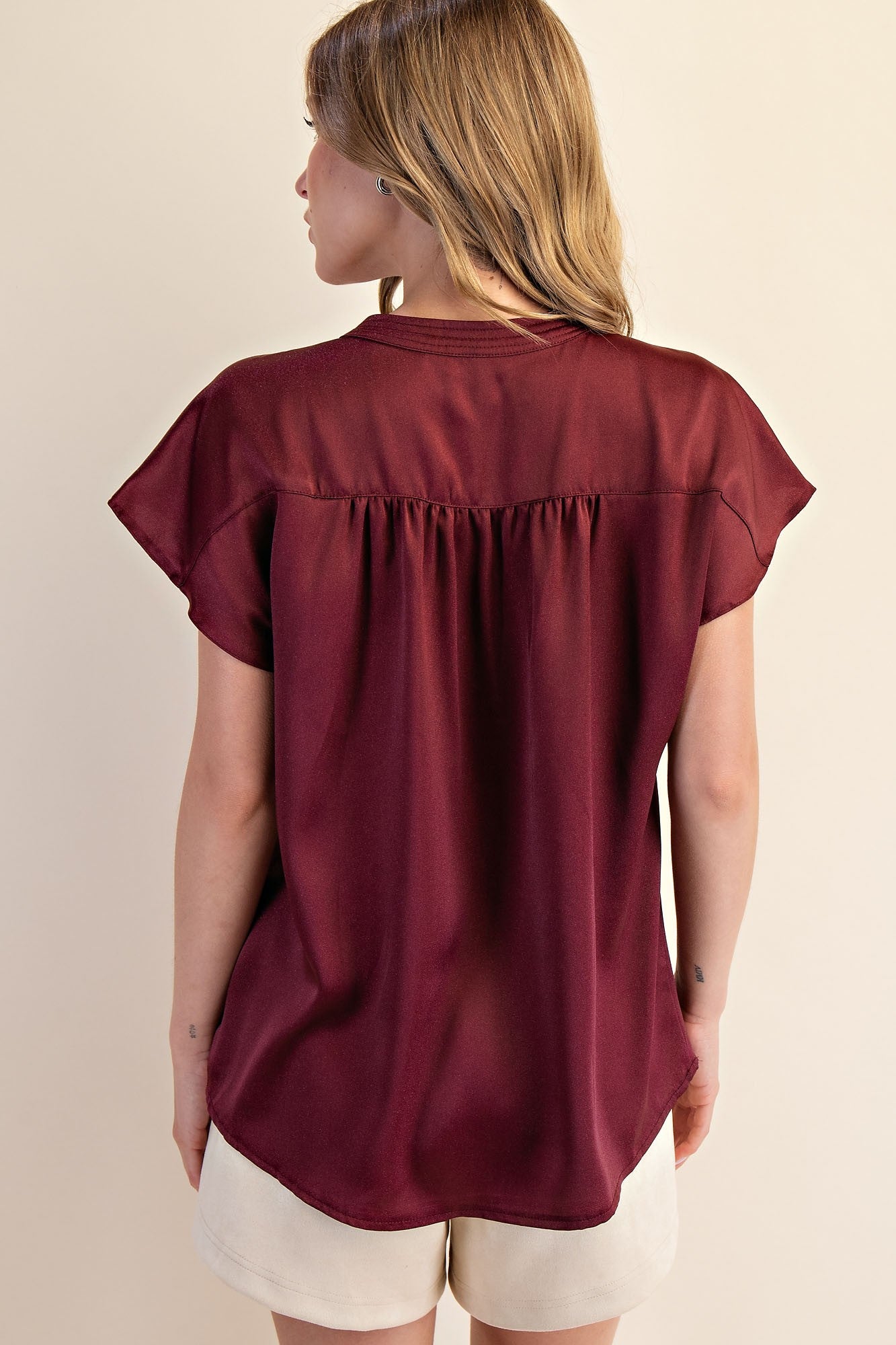 Jami Drop Cap Sleeve Satin Blouse in burgundy with gathered back detail. Sizes: XS-XL.