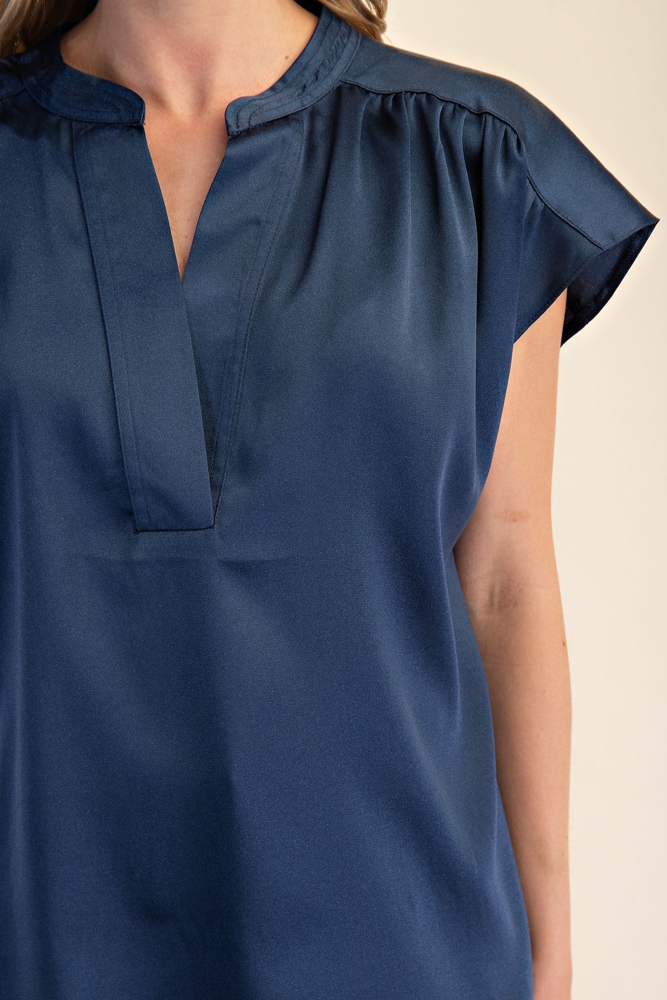 Jami Drop Cap Sleeve Satin Blouse: short-sleeve, dark blue, split V-neck, gathered shoulders. Available in sizes XS-XL.