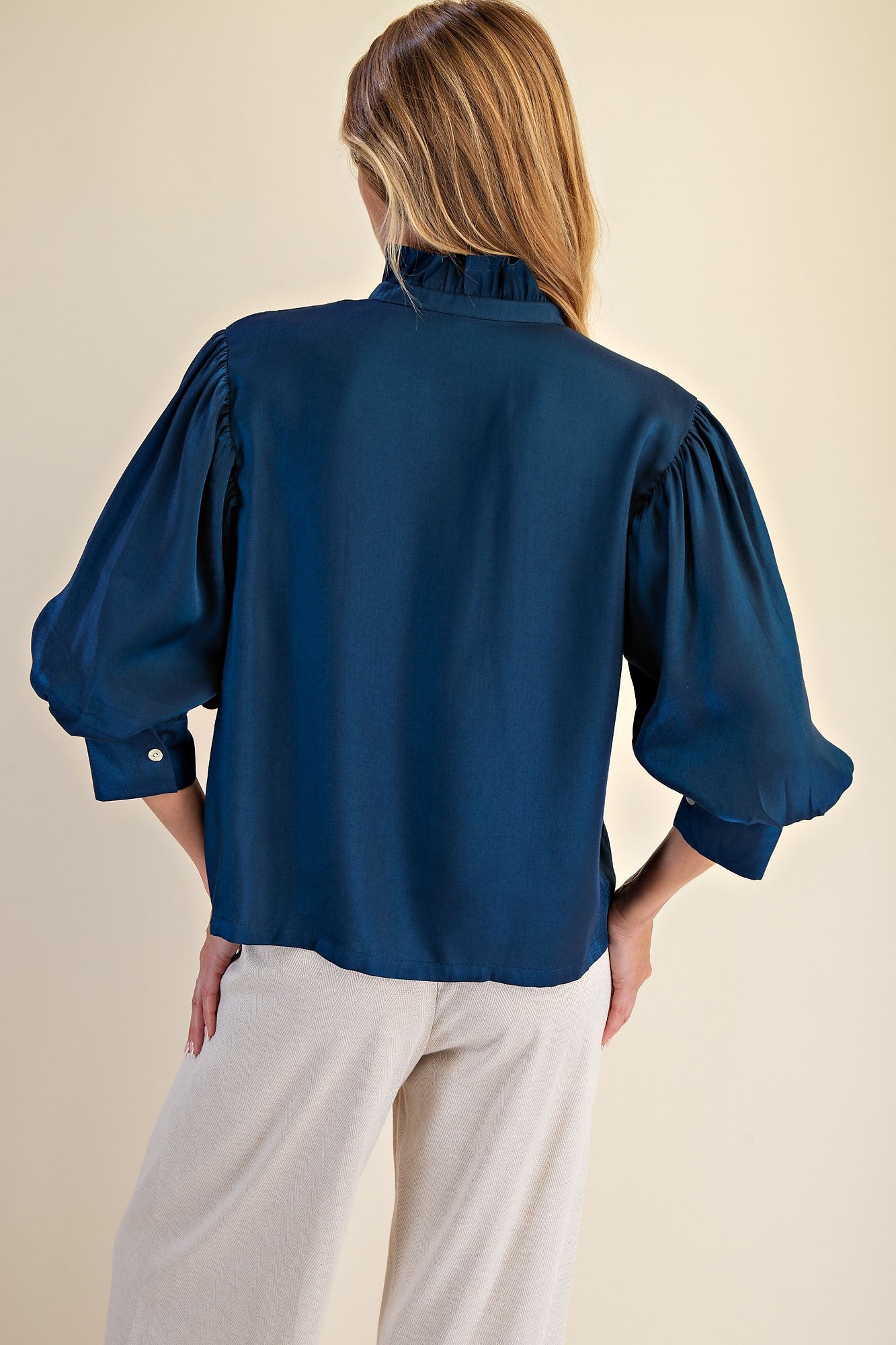 Peacock Blue Ruffle Neck Puff Sleeve Blouse with three-quarter puffed sleeves; available in sizes XS-XL.
