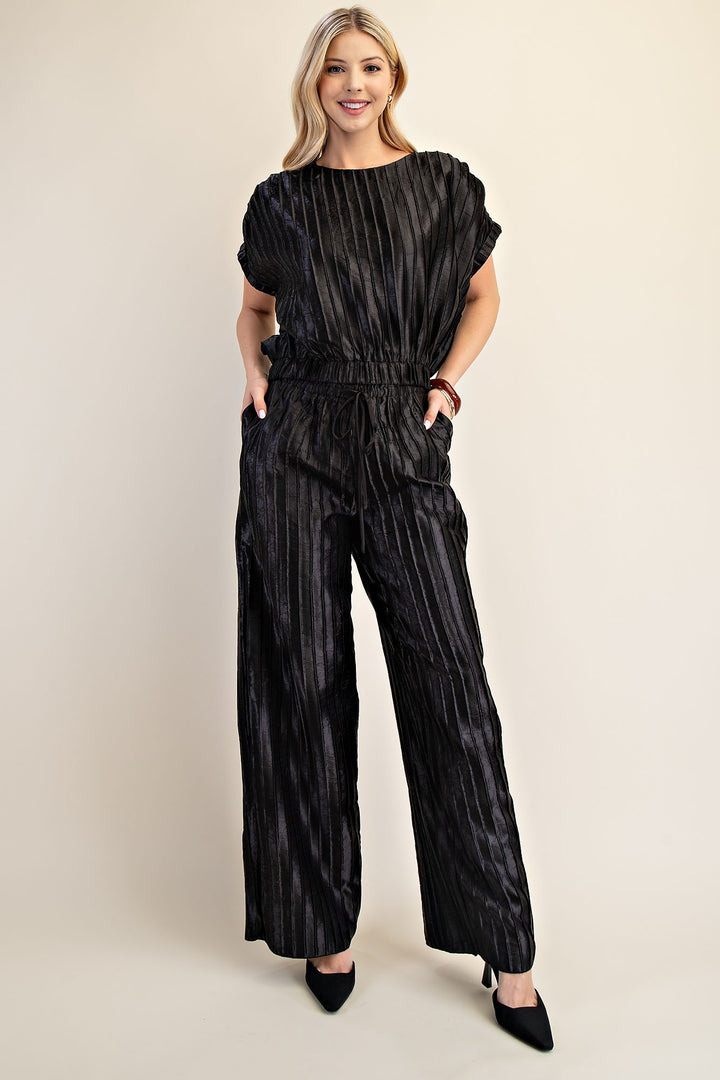 Pitch Flowy Pants: loose-fitting, black, pinstriped wide-leg pants. Available in sizes XS–XL.