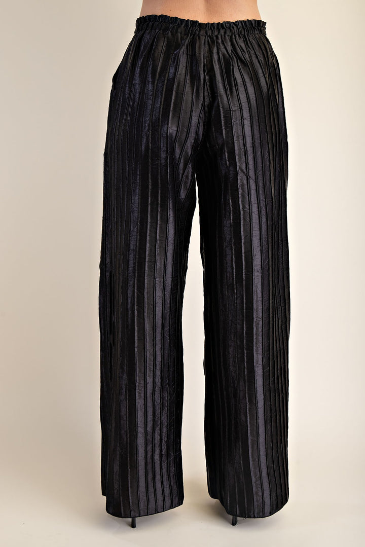 Pitch Flowy Pants: metallic fabric, pleated wide-leg, elastic waistband. Available in sizes XS–XL.