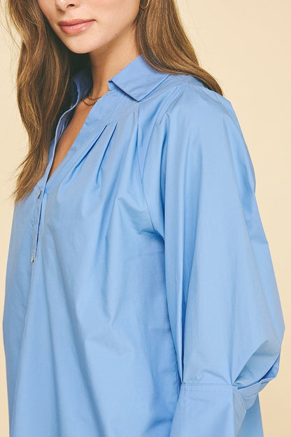 French Blue V-Neck Collar Wide Cuff Shirt, loose fit, 100% cotton, wide sleeves and collar. Available in sizes XS–XL.