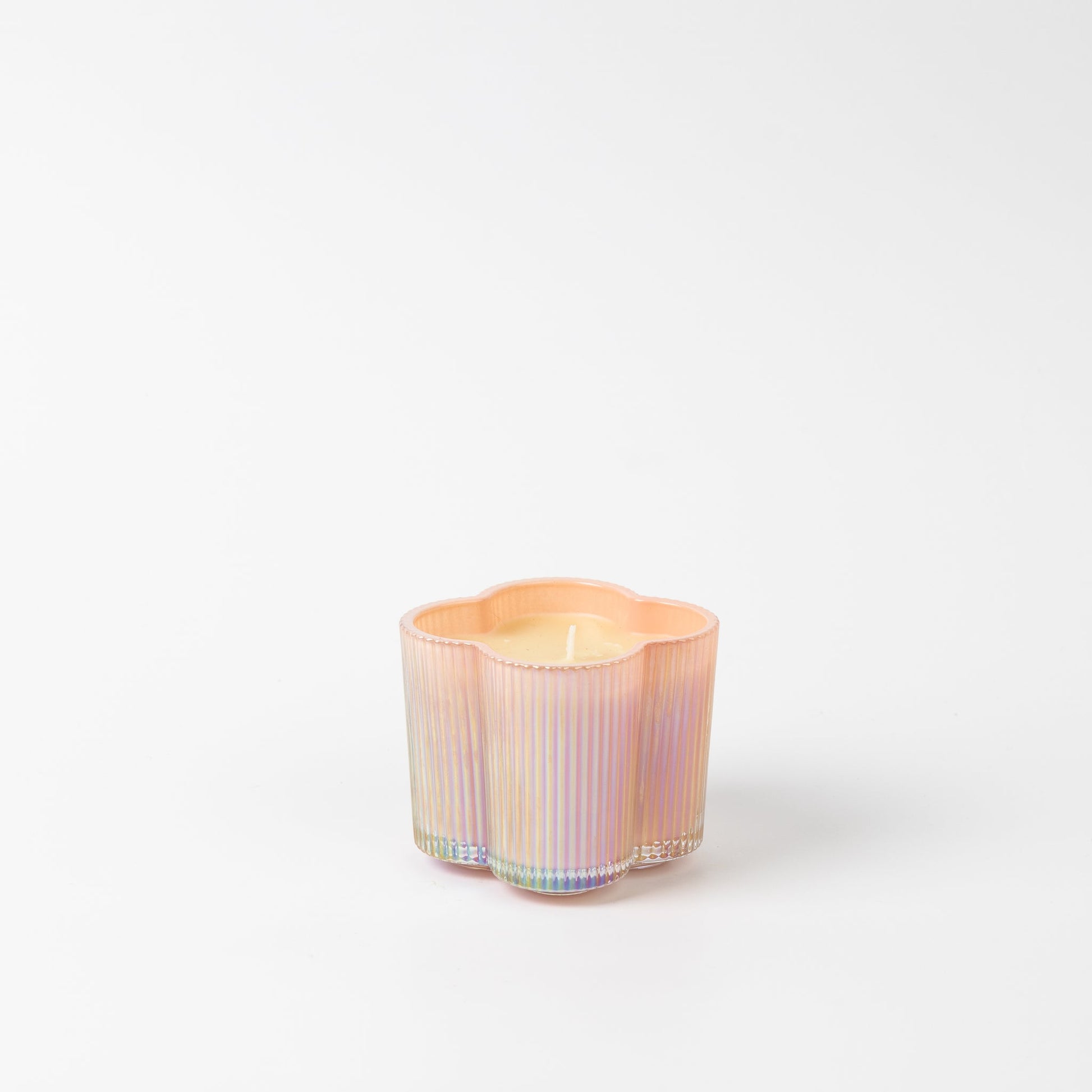 Sweet Grace Collection Flower Candle, 7.2 oz, in pastel iridescent glass with vertical ridges and floral-shaped soy-blend wax.
