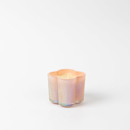 Sweet Grace Collection Flower Candle, 7.2 oz, in pastel iridescent glass with vertical ridges and floral-shaped soy-blend wax.